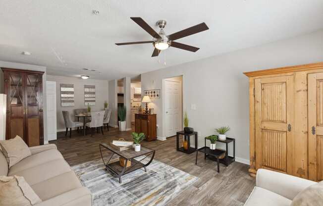 a living room with a couch and a ceiling fan