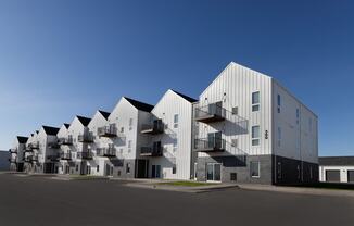 modern apartment buildings with balconies and a blue sky