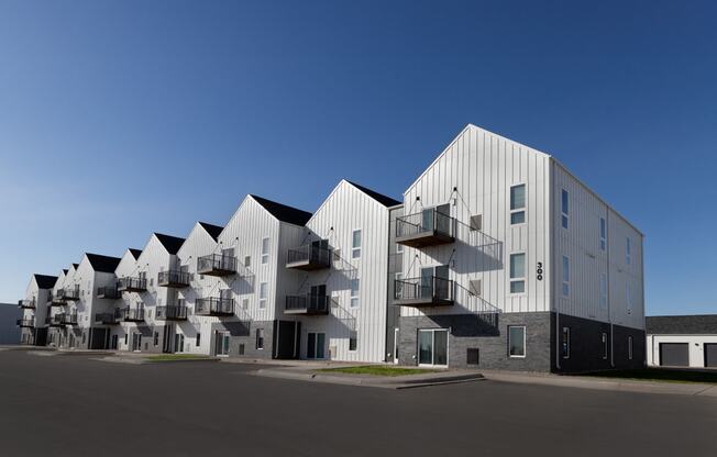 modern apartment buildings with balconies and a blue sky