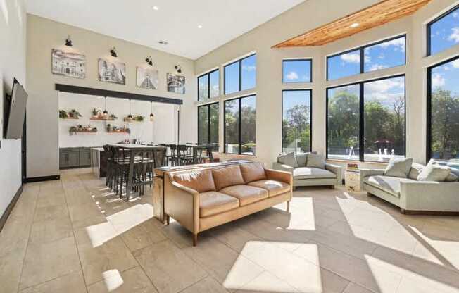 a living room with a couch and a table in front of a large window