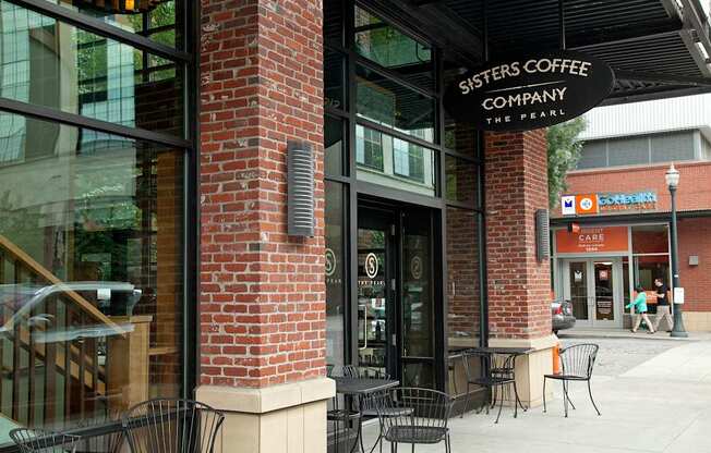 A brick building with a sign that says Sisters Coffee Company.