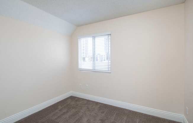 Carpeted bedroom at the Atrium Apartments in San Diego, California.