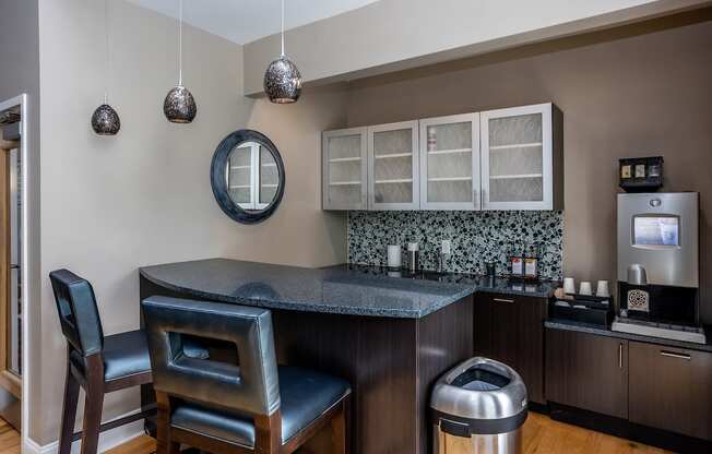 a kitchen with a counter top and two chairs