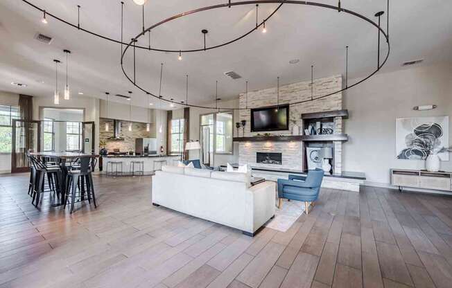 A modern living room with a fireplace and a TV mounted above it.