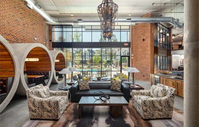 Resident clubhouse with many seating areas with couches, work booths, and chairs