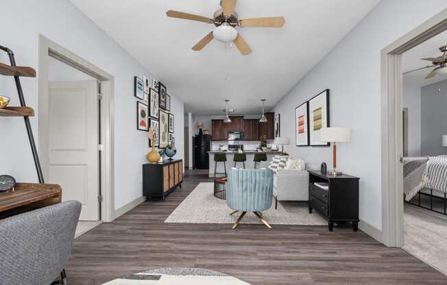 a living room and kitchen with a ceiling fan at the Vue apartments in Indianapolis
