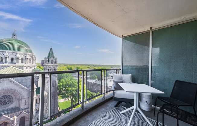 an apartment with a balcony and a view of the basilica of the sacre coeur