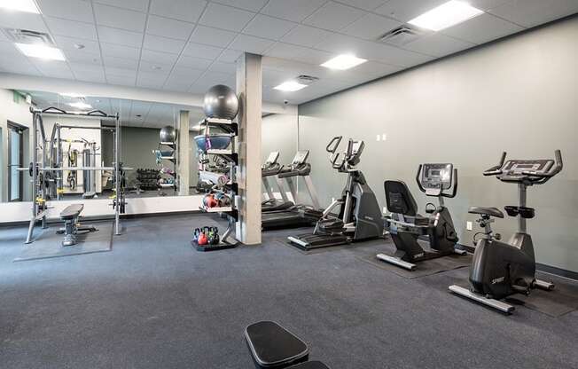 a large fitness room with treadmills and other exercise equipment at QUINN BY VINTAGE, Shoreline, WA