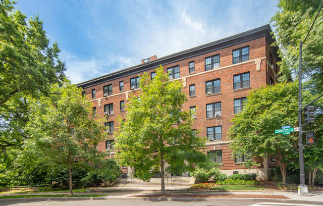 a large red brick building with trees in front of it