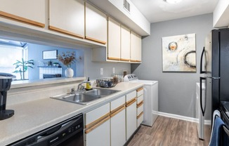 a kitchen with white cabinetry and gray walls