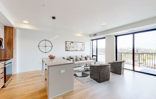 a living room with a couch and a table and a kitchen