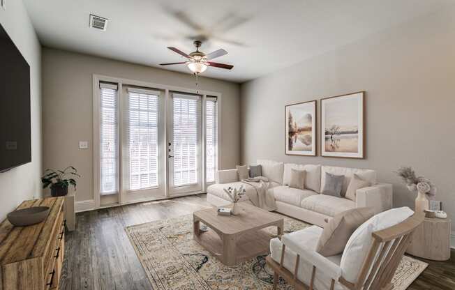 an open living room with a ceiling fan and a couch