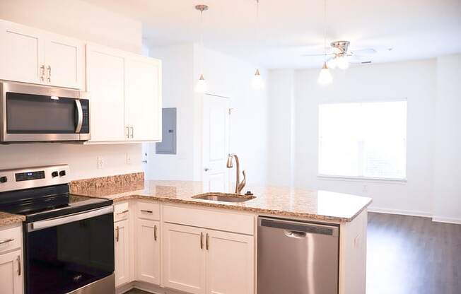 a kitchen with white cabinets and a counter top