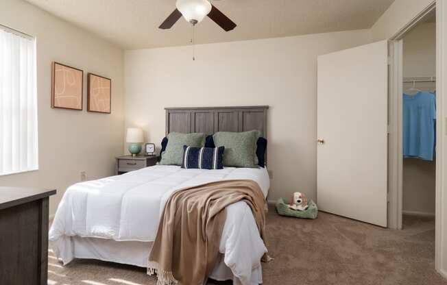 a bedroom with a bed and a ceiling fan