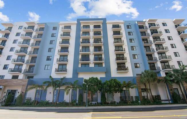 A large apartment building with balconies and doors.