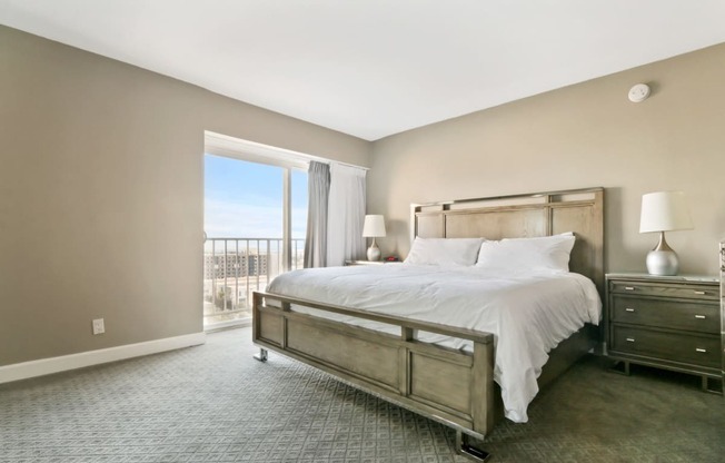 Bedroom with carpet floorings, balcony with great views on the left