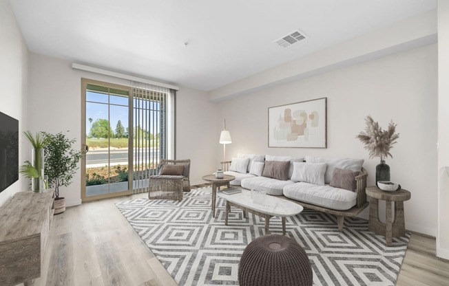 a living room with a white couch and a large rug