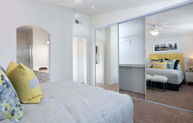 a bedroom with a bed and a mirror
