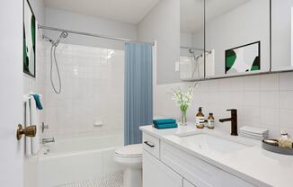 Laurel West End Apartments in Golden Valley, MN photo of a bathroom with white tiles and a blue shower curtain