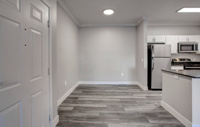 a kitchen with a refrigerator freezer and a stove top oven