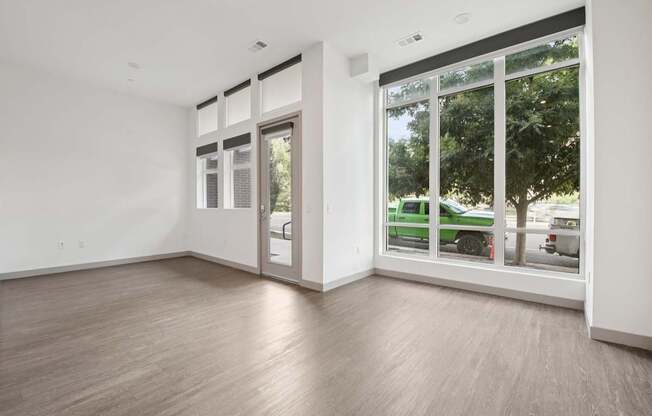 A room with a sliding glass door leading to a backyard.