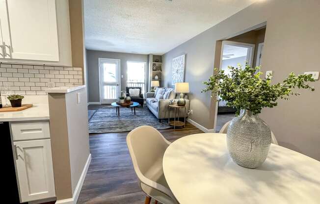 an open living room and dining room with a table and chairs