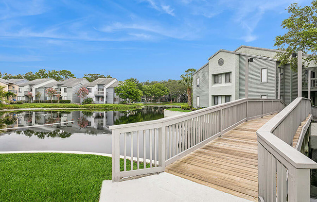 Community Pond and Walking Bridge at Huntington Place Apartments located in Sarasota, FL.