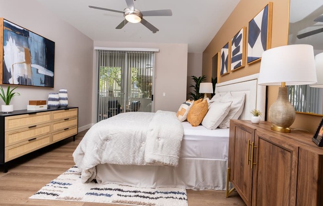 a bedroom with a bed and a ceiling fan