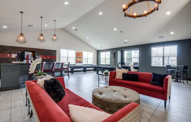 a living room with couches and chairs and a kitchen with a bar and tables