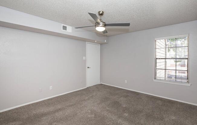 a large empty room with a sink and a mirror