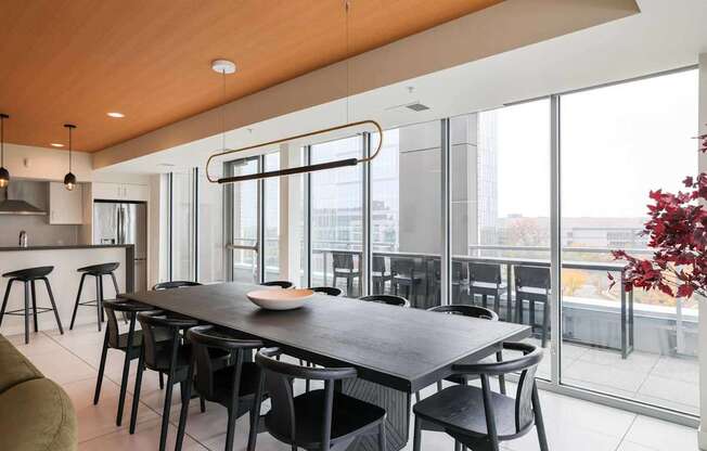 A modern dining room with a large table and chairs.