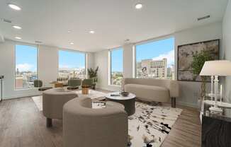 a living room with couches and chairs and a view of the city