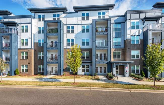 an exterior view of an apartment building on a city street