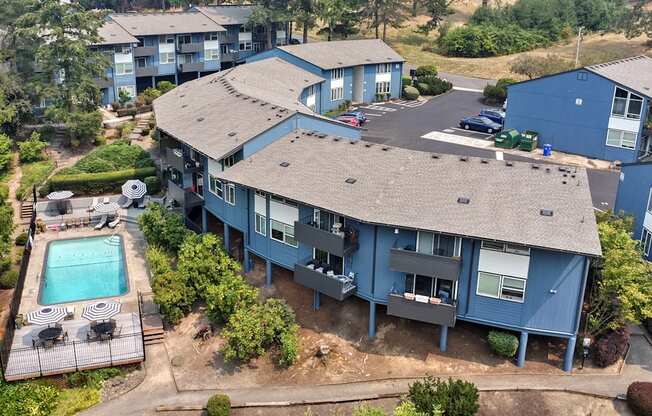 A blue house with a pool in the backyard.