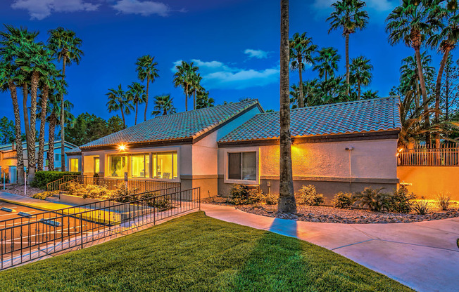 A house with a palm tree in front of it.
