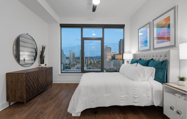 a bedroom with a large bed and a large window at Stanza Little Italy, San Diego, CA, 92101