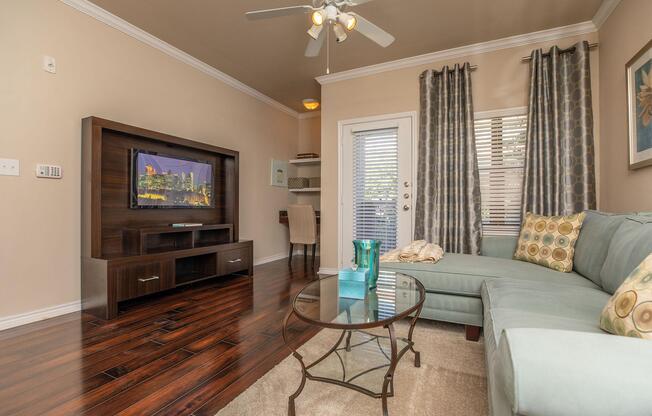 a living room filled with furniture and a flat screen tv