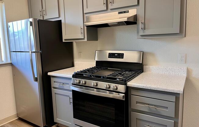 a stove top oven sitting inside of a kitchen