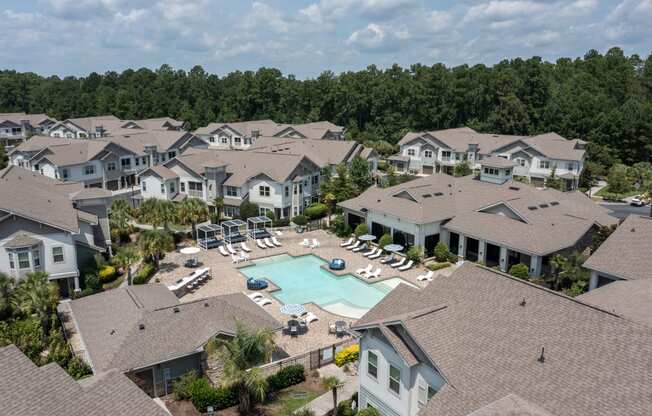 an aerial view of a swimming pool surrounded by houses