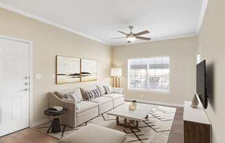 a living room with a couch and a ceiling fan