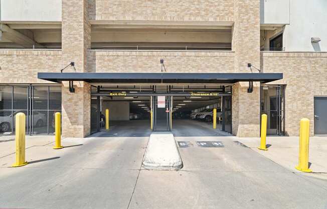 A parking garage entrance with a sign that says "Entrance 1".