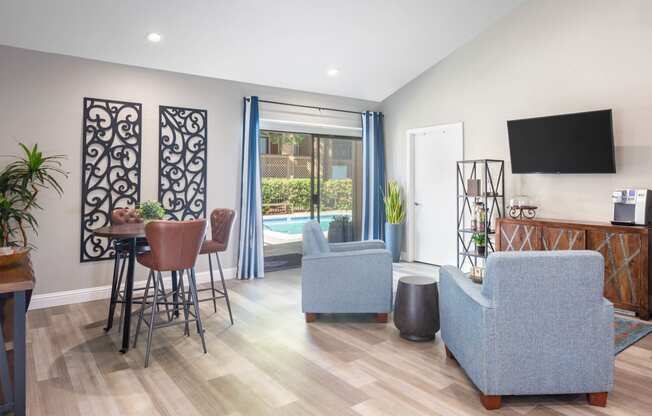 a living room with a table and chairs