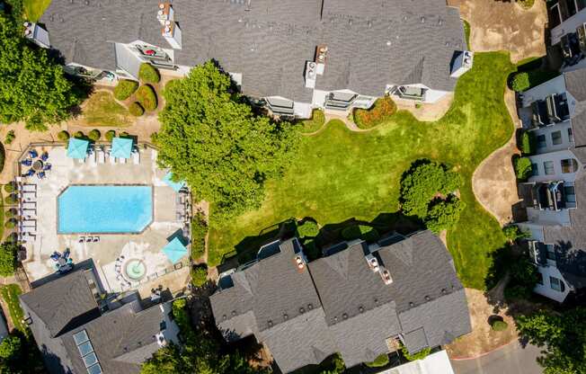 arial view of a house with a pool and yard