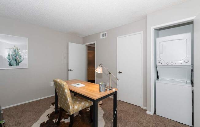 A small room with a desk and a chair.