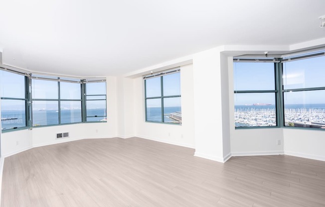 A room with a large window overlooking a cityscape.