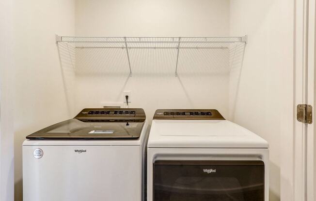 a laundry room with two washes and a dryer