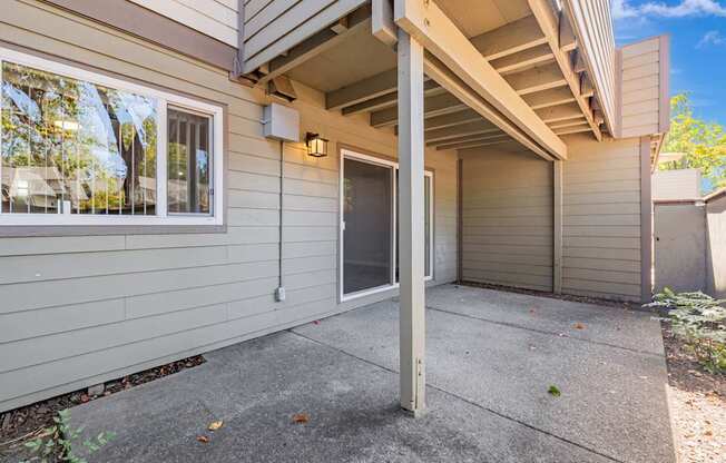 A house with a grey wall and a grey door.