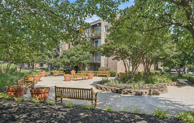 Community Courtyard with Benches and Flower Pots at Mason Van Dorn Apartments located in Alexandria, VA.