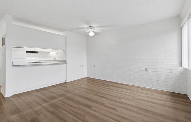 A room with wooden flooring and white walls.