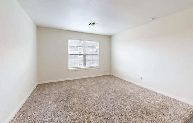 a bedroom with white walls and a window at Bennett Ridge Apartments, Oklahoma City, OK, 73132